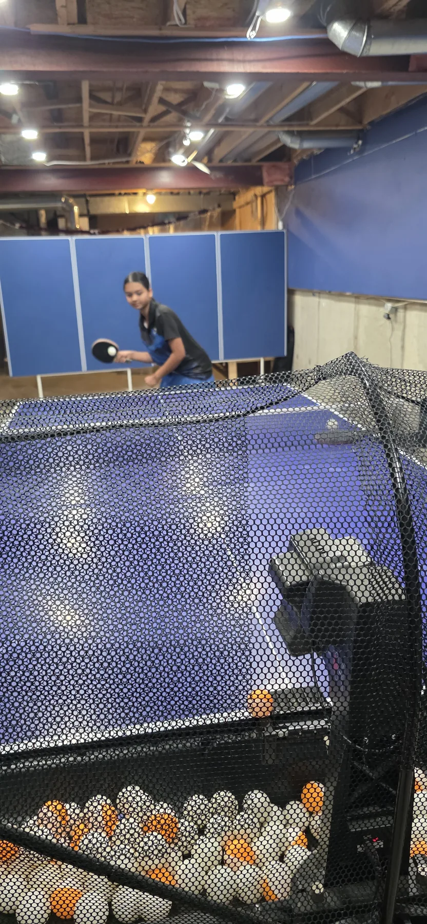 Young player practising with the table tennis robot at the Barrhaven club